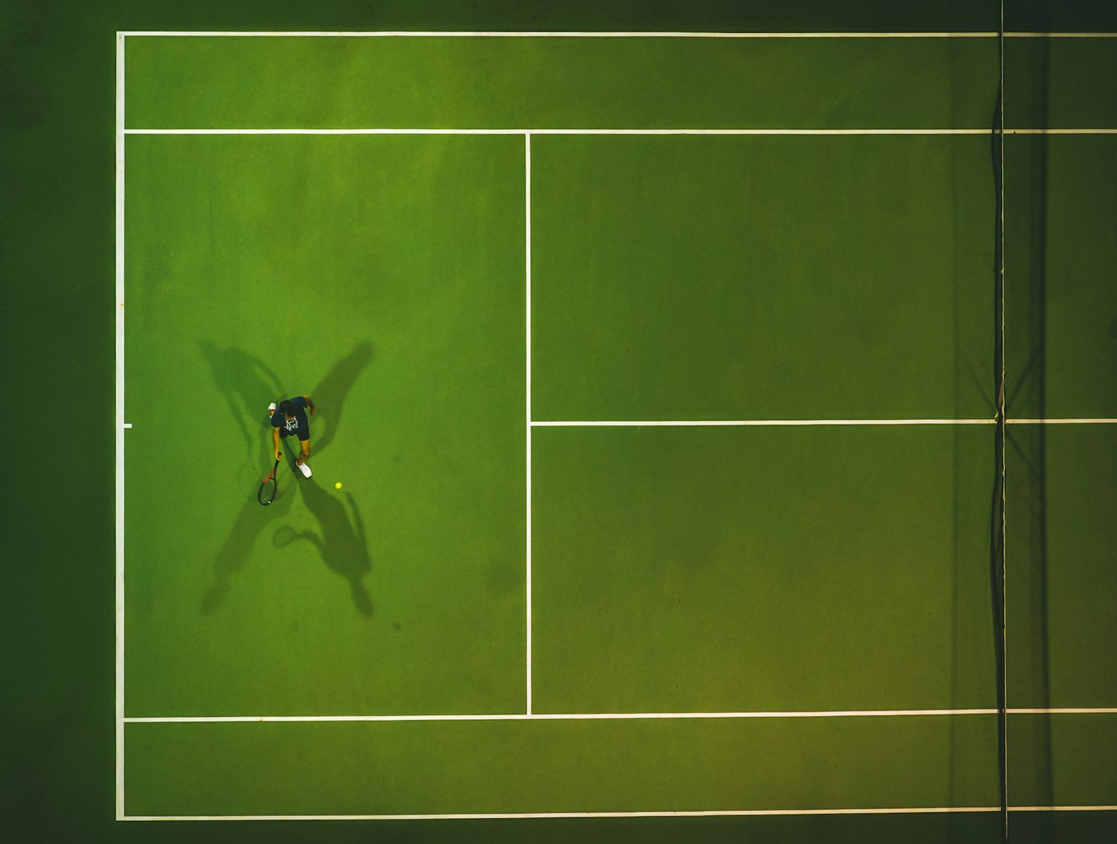 View of a Tennis player and tennis court from above.
