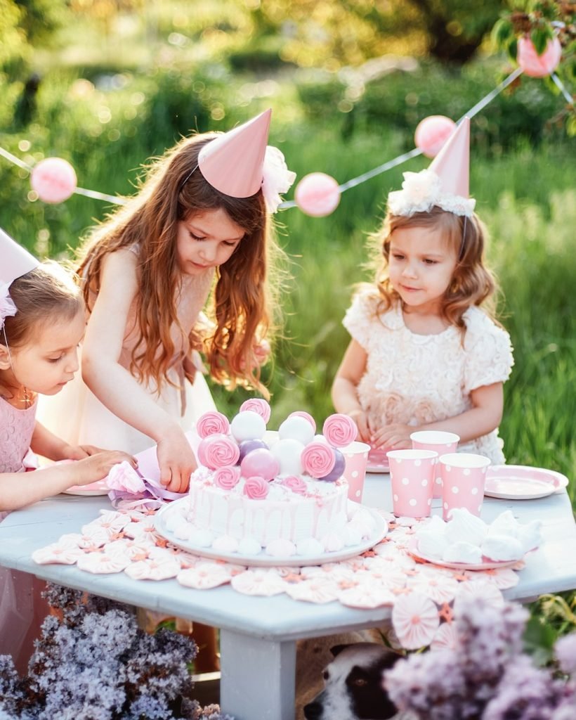 Summer outdoor kids birthday party. Group of happy Children celebrating birthday in park